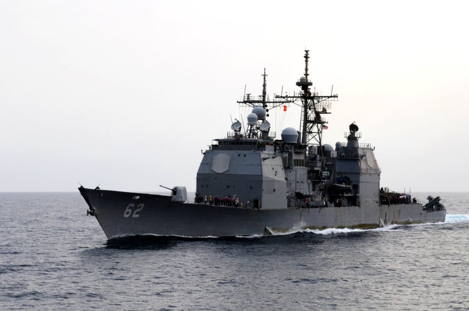 US Navy 110728-N-SB672-135 USS Chancellorsville (CG 62) transits alongside USS Ronald Reagan (CVN 76) for a fueling at sea