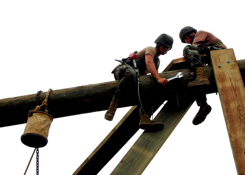 US Navy 110728-N-SD610-001 Seabees secure bolts during the construction of a heavy timber tower structure