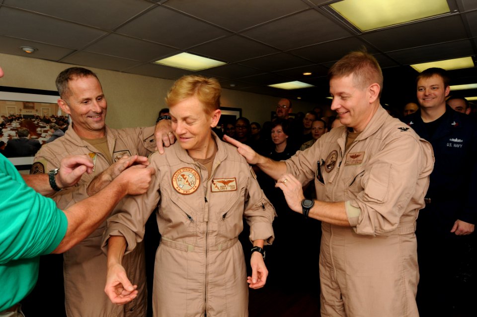 US Navy 110731-N-XE109-005 Rear Adm. Nora W. Tyson is pinned to rear admiral upper half by Capt. Jeffery A. Davis, left, and Capt. Brian E. Luther