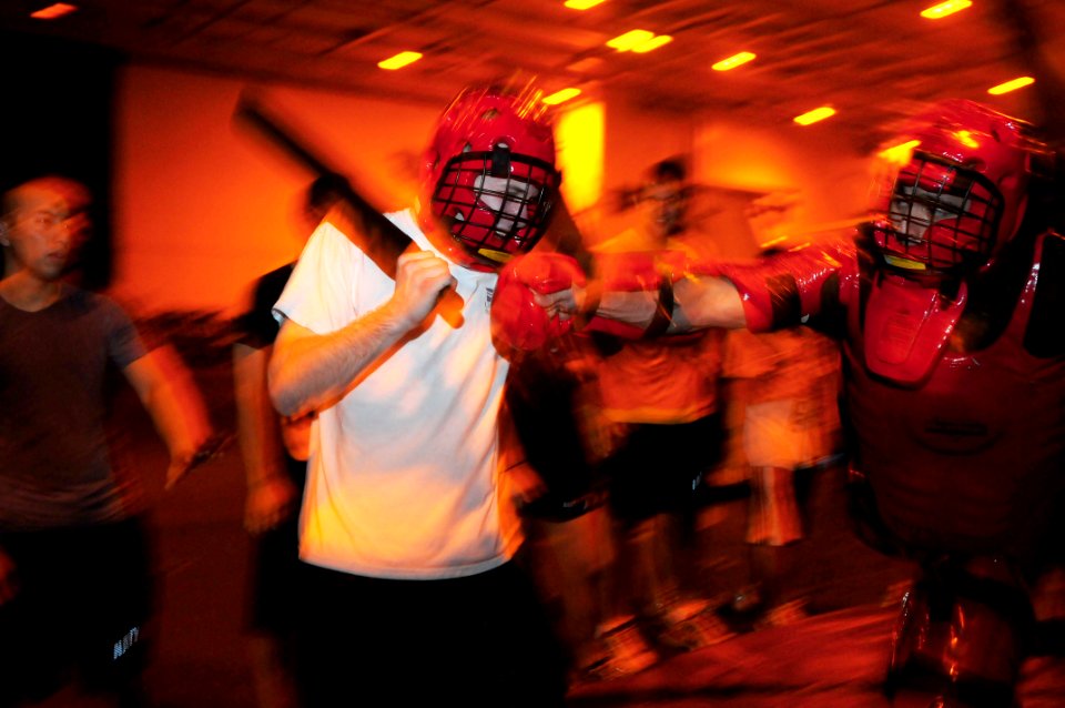 US Navy 110728-N-SB672-099 Master-at-Arms 2nd Class Anthony Soto, right, hits a Sailor during a Security Reaction Force-Basic course in the hangar