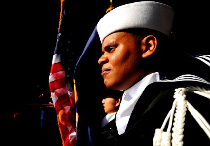 US Navy 110801-N-ZZ999-026 Information Systems Technician Seaman Wellington Camarena serves as a member of the color guard aboard the Nimitz-class