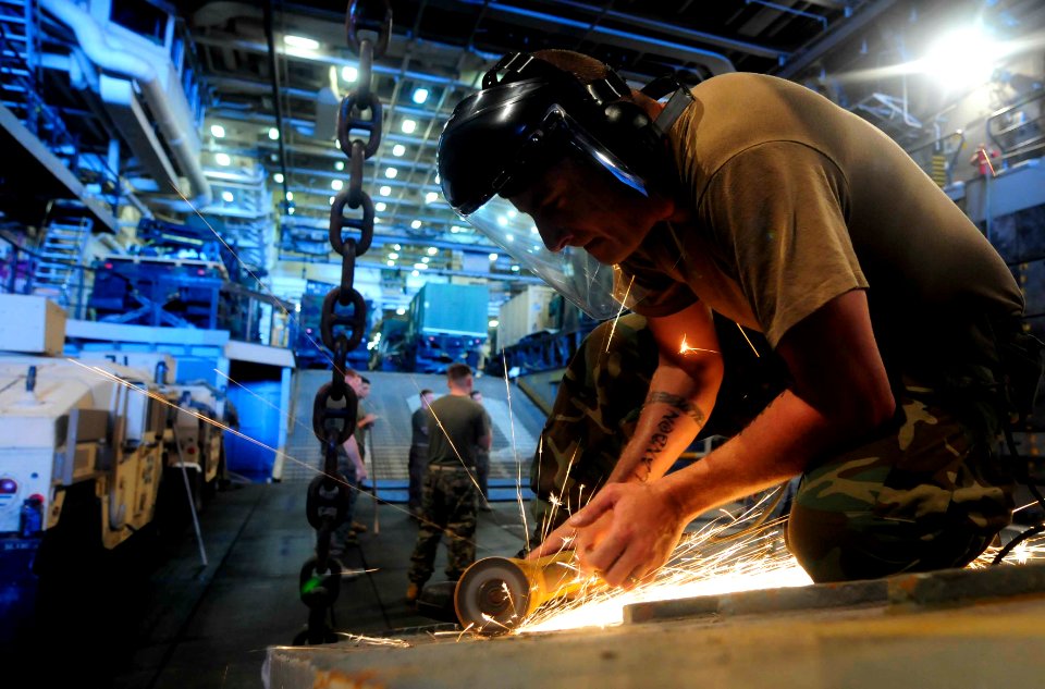 US Navy 110802-N-OS574-028 Electrician's Mate 2nd Class Neil Hutchison makes repairs on a landing craft utility assigned to Assault Craft Unit (ACU
