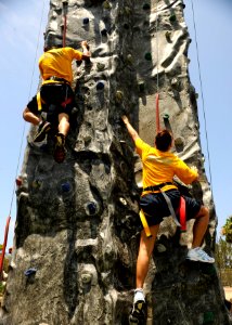 US Navy 110729-N-UB993-093 Hospitalman Evelyn Roca, right, makes her way through the bounce house obstacle course wearing vision impairing goggles