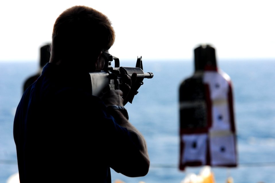 US Navy 110729-N-UO379-024 Gunner's Mate 2nd Class Vincent Soldani, from Albany, N.Y., aims an M-16A2 assault rifle at a target during a live-fire