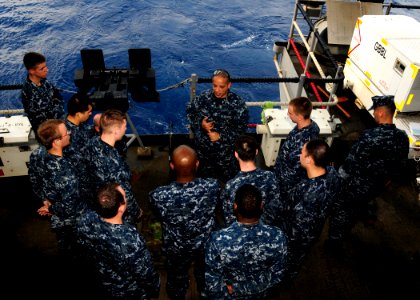 US Navy 110803-N-JO245-003 Master-at-Arms 2nd Class Jose Caban, center, from San Sebastian, Puerto Rico, gives Sailors a safety brief before a live