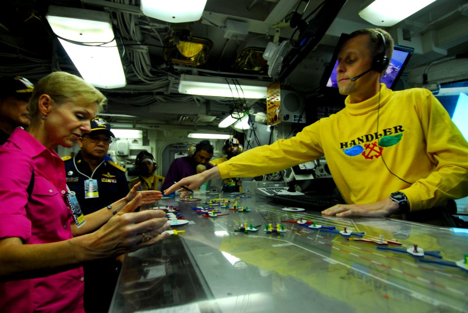 US Navy 110805-N-AW206-064 Handler Lt. Cmdr. Eric Harrington explains flight deck operations to U.S. Ambassador to Thailand Kristie A. Kenney