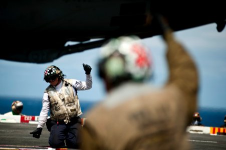 US Navy 110730-N-BT887-191 Aviation Ordnanceman 1st Class Justin Thomas gives the approval to launch an F-A-18E Super Hornet aboard USS John C. Ste