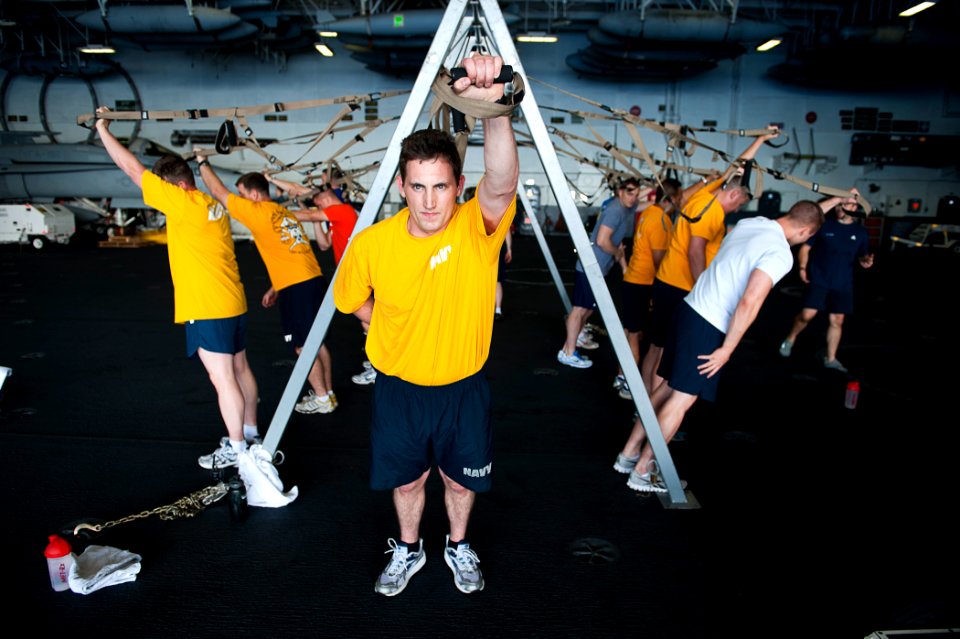 US Navy 110804-N-BT887-129 Seaman David Lipscomb, from Dallas, participates in group fitness in the hangar bay of the Nimitz-class aircraft carrier