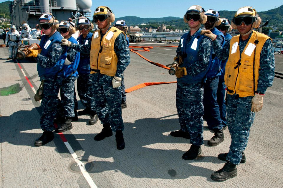 US Navy 110804-N-KM175-008 Aviation boatswain's mates man fire hoses during an aviation damage control drill aboard the forward deployed amphibious