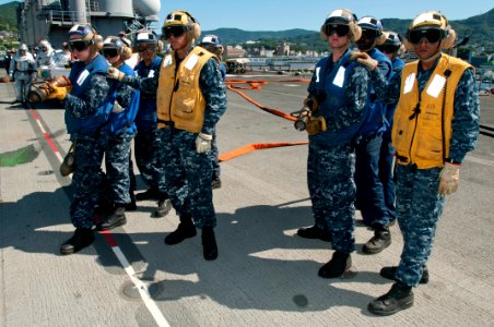 US Navy 110804-N-KM175-008 Aviation boatswain's mates man fire hoses during an aviation damage control drill aboard the forward deployed amphibious