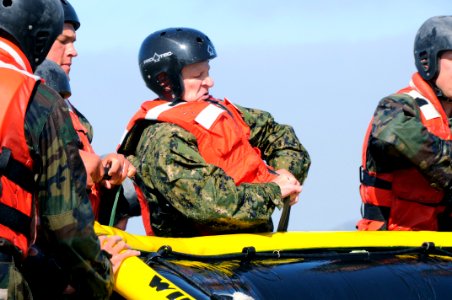 US Navy 110805-N-JR159-161 Master Chief Petty Officer of the Navy (MCPON) Rick D. West, center, participates in surf passage at Naval Amphibious Ba