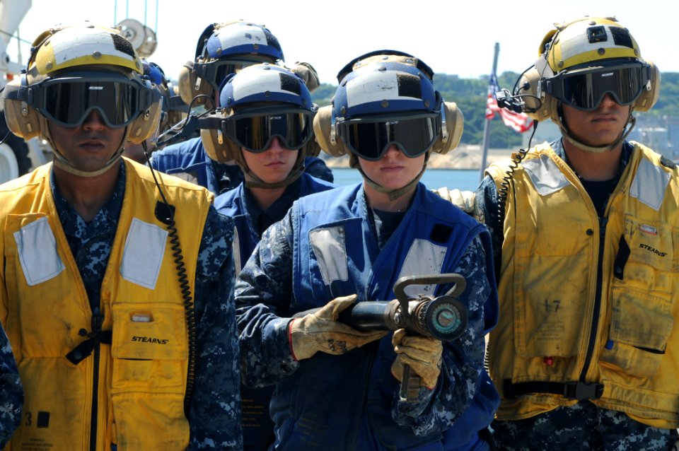 US Navy 110804-N-SO729-046 Aviation boatswain's mates stand ready to engage a fire during an aviation damage control drill aboard the forward-deplo