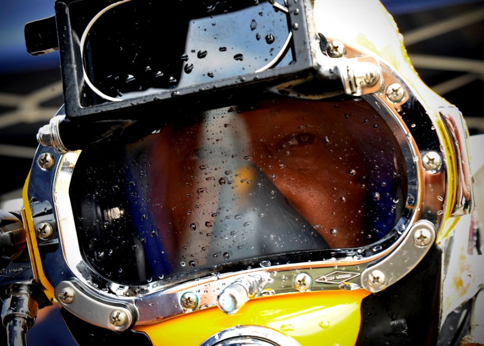 US Navy 110804-N-KB666-096 Lt. j.g. Christopher Yee Sing prepares to be un-hatted after conducting joint dive operations