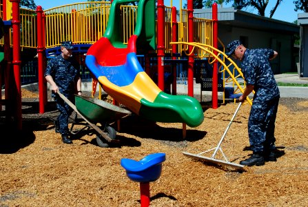 US Navy 110808-N-CI293-147 Machinist's Mate 2nd Class Jonathan Hanson and Aviation Structural Mechanic 2nd Class Jesse Voelk help replace wood chip