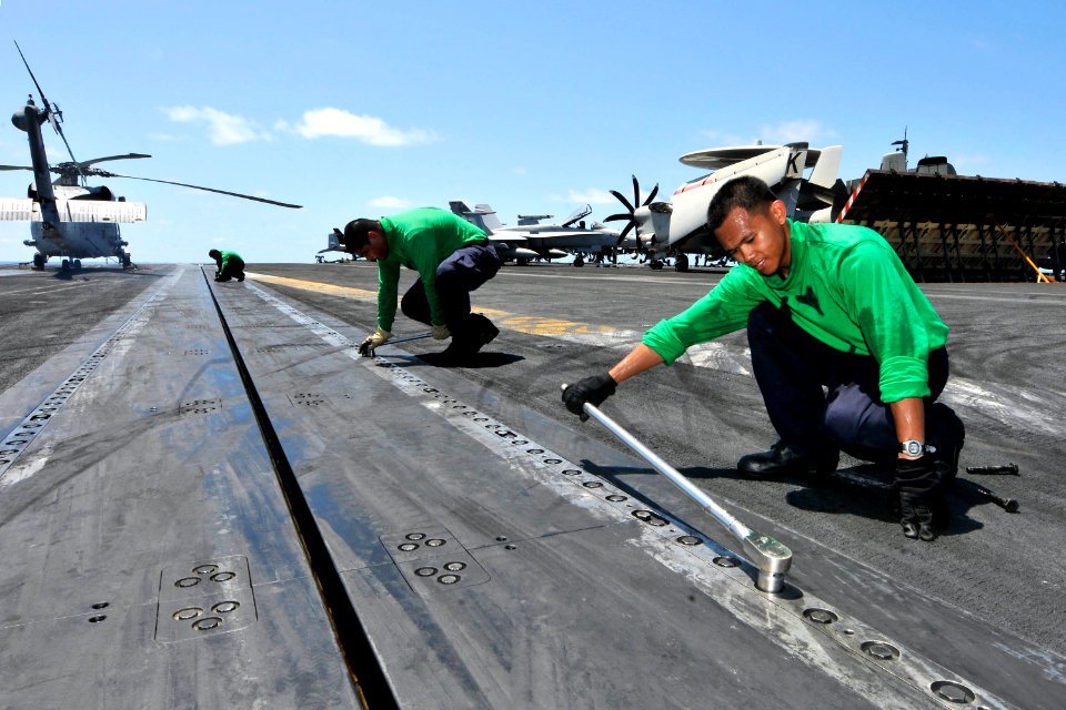 US Navy 110805-N-EE987-129 Aviation Boatswain's Mate (Equipment) Airman Troyphilip Obuga, from the Philippines, uses a torque wrench