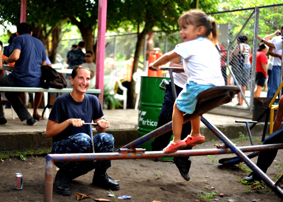 US Navy 110803-N-NY820-383 Hospital Corpsman 3rd Class Jennifer Nuehring, from Elgin, Ill., plays with a child at the Escuela Fray Casiano de Madri