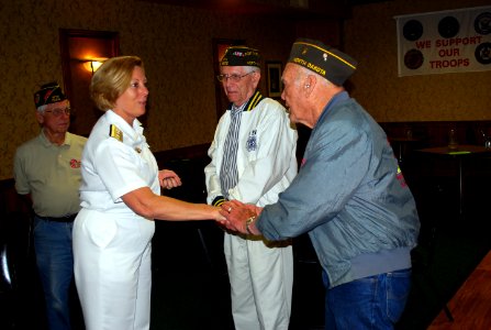 US Navy 110809-N-CI293-192 Rear Adm. Patricia E. Wolfe, commander of Navy Expeditionary Logistics Support Group, presents coins to World War II