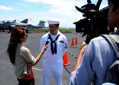 US Navy 110806-N-DS193-001 Mass Communication Specialist 2nd Class Adam K. Thomas, from St. Louis, interviews with Thai Asean TV reporter Vijitra