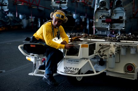US Navy 110804-N-BT887-039 Aviation Boatswain's Mate 3rd Class Marlon Squires, from Stockton, Calif., maneuvers an MH-60S Sea Hawk helicopter