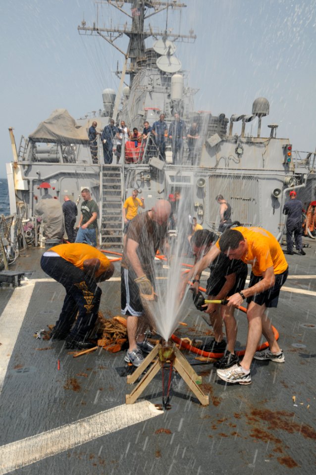 US Navy 110805-N-XQ375-177 Sailors patch a leaking pipe during a damage control Olympics aboard USS Mitscher (DDG 57)