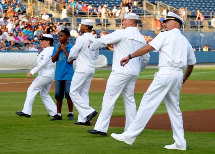 US Navy 110806-N-JP983-033 Sailors representing air, submarine and surface commands throw the first pitch during a Norfolk Tides baseball game at H