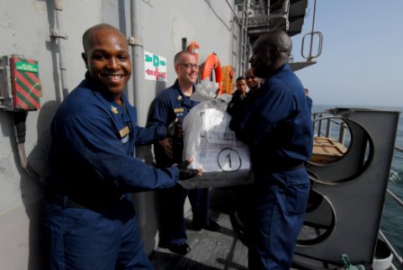 US Navy 110804-N-DU438-444 Chief petty officer selects pass a bag of mail down the line during an all-hands working party aboard the guided-missile