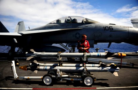 US Navy 110809-N-ZZ999-162 Aviation Ordnanceman 3rd Class Trevor Fleshman prepares to load ordnance on an F-A-18F Super Hornet aboard USS John C. S