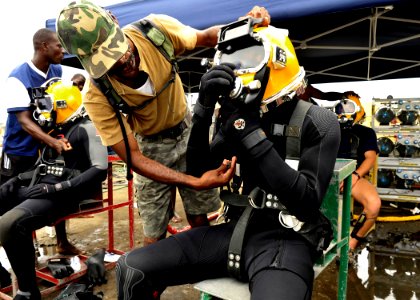 US Navy 110804-N-KB666-017 Lt. j.g. Peter Wilson-Kelly, center, ensures Leading Seaman Richard Nicholson, right, is ready to dive as Ordinary Seama photo