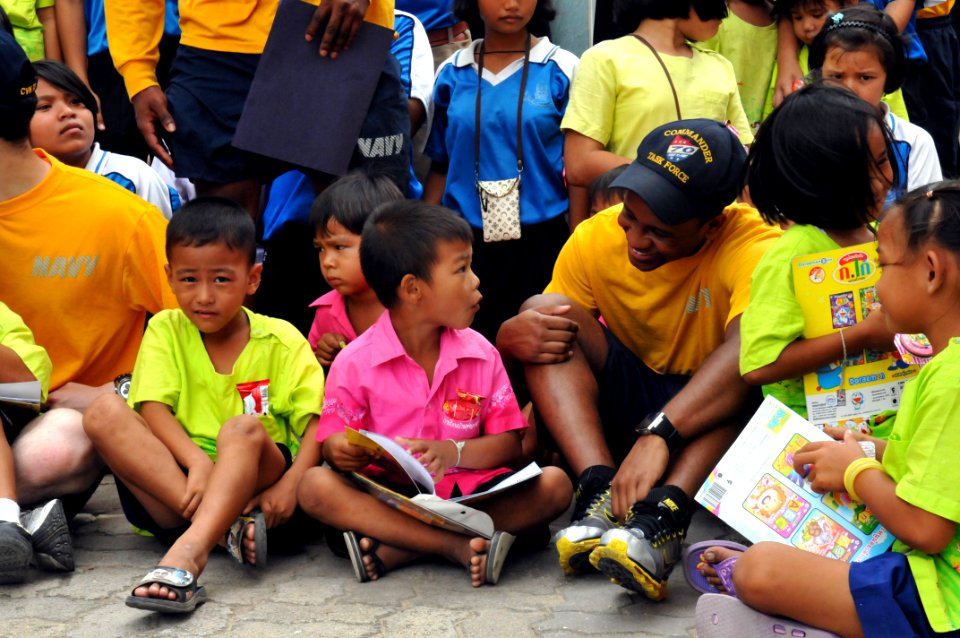 US Navy 110809-N-WW409-231 Yeoman Seaman Cedric Evans plays with students at the Wat Hua Yai School during a community service event in Pattaya, Th