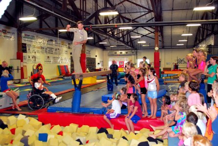 US Navy 110810-N-CI293-160 Cmdr. Shannon Tolliver walks the plank at the TNT Kids Fitness and Gymnastics Academy