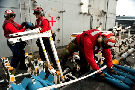 US Navy 110809-N-BT887-201 Sailors position dummy ordnance aboard USS John C. Stennis (CVN 74)