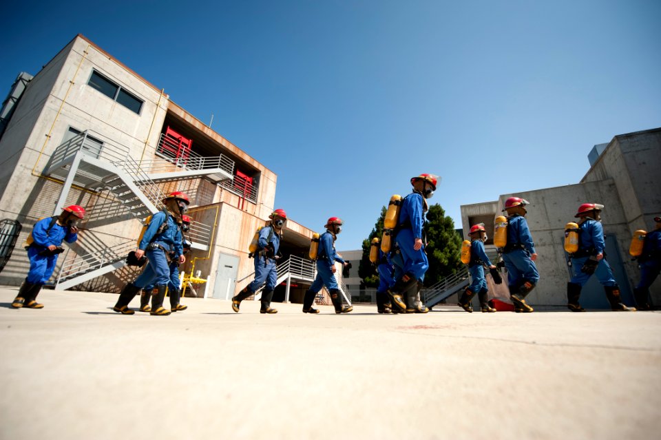 US Navy 110824-N-DR144-927 Japan Maritime Self-Defense Force sailors proceed to a firefighting scenario at the Center for Naval Engineering Firefig