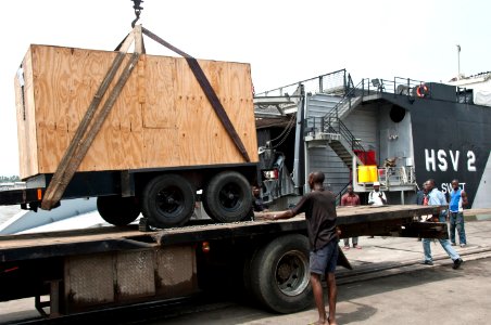 US Navy 110810-N-XK513-064 A generator is prepared for delivery from the High Speed Vessel Swift (HSV 2) to the Reformed Combined Secondary School photo