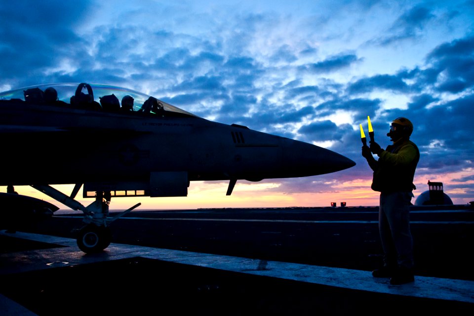US Navy 110809-N-BT887-329 Lt. Cmdr. (Select) Dave Toline directs an F-A-18F Super Hornet aboard USS John C. Stennis (CVN 74)