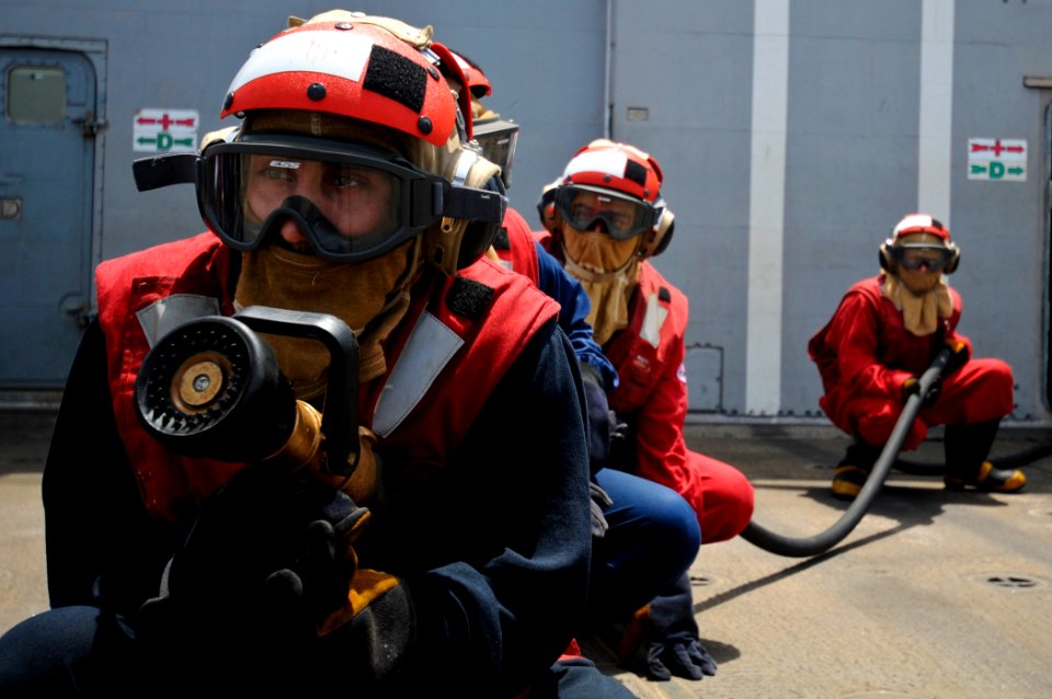 US Navy 110810-N-YM590-035 Navy Sailors man an aqueous film forming foam hose during a flight deck fire drill aboard the guided-missile cruiser USS
