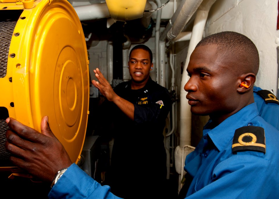 US Navy 110810-N-OV802-915 Lt. Aaron Jefferson, left, takes Kenyan navy 2nd Lt. Eric Ashitiba on a tour of the engineering spaces aboard the guide