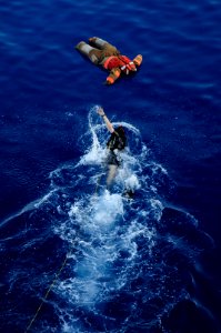 US Navy 110811-N-WV964-019 Search and rescue swimmer Lt. j.g. Daniel Royal swims towards a body during a man overboard recovery drill