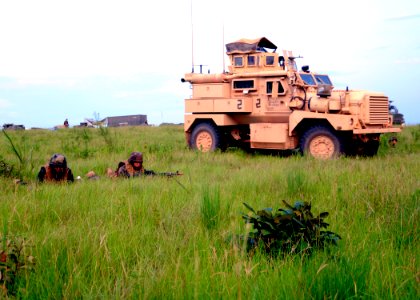 US Navy 110807-N-SD610-003 Seabees assigned to Naval Mobile Construction Battalion (NMCB) 7 stand defensive security in anticipation of an aggresso