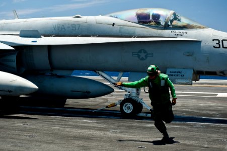 US Navy 110811-N-BT887-063 A Sailor gives the approval to launch an F-A-18E Super Hornet from the Black Aces of Strike Fighter Squadron (VFA) 41