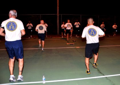 US Navy 110812-N-OH262-012 Chief petty officer selectees lead the Chief's Mess in an exercise during physical fitness training at Naval Station Gua photo