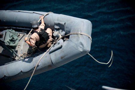 US Navy 110812-N-PB383-004 A Sailor assigned to the USS New Orleans (LPD 18) heaves a line on a rigid-hull inflatable boat before a practice missio