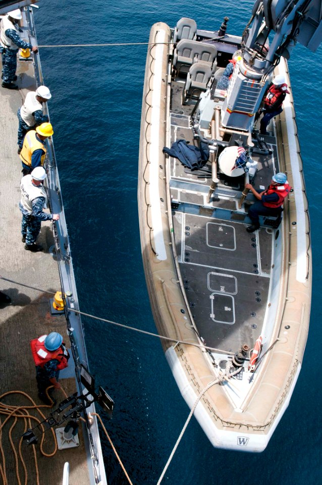 US Navy 110810-N-PB383-162 Sailors lower the rigid-hull inflatable boat into the water aboard USS New Orleans (LPD 18