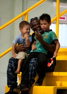 US Navy 110810-N-NY820-269 Hospitalman Michael Buertey visits with children during a community service medical event at the Barranca Municipal Gym photo