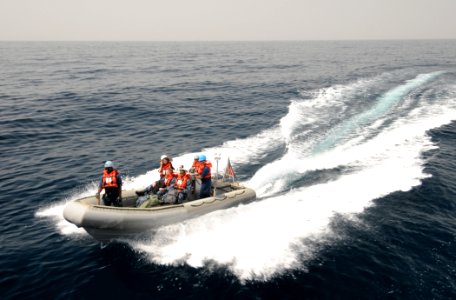 US Navy 110812-N-XQ375-181 A rigid-hull inflatable boat returns to the guided-missile destroyer USS Mitscher (DDG 57), not shown, during a personne photo