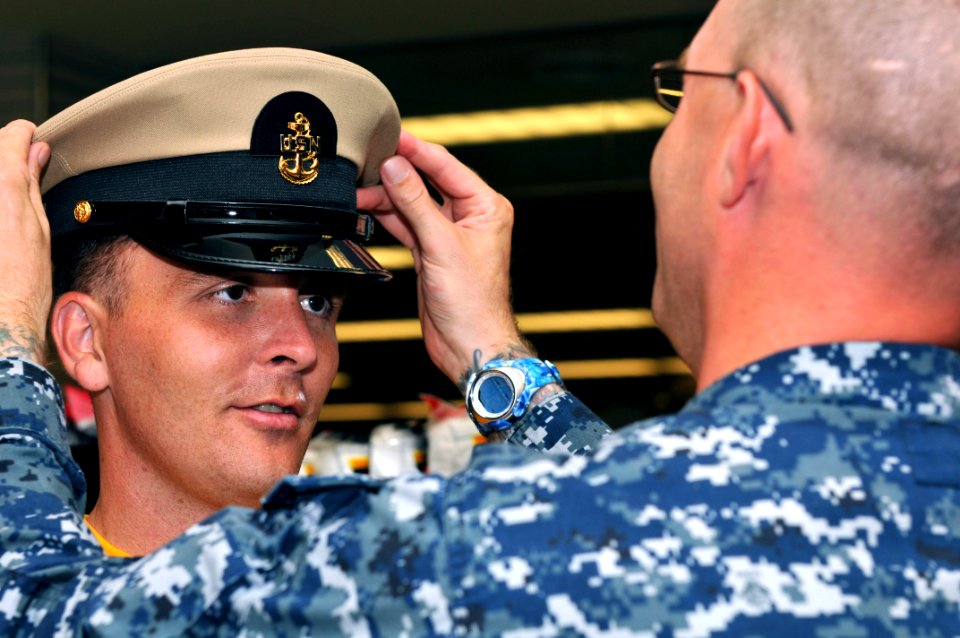 US Navy 110811-N-ER662-039 Chief Machinist Mate (Select) Robert F. McKinney gets fitted for his new combination cover during the NEX Uniform Night