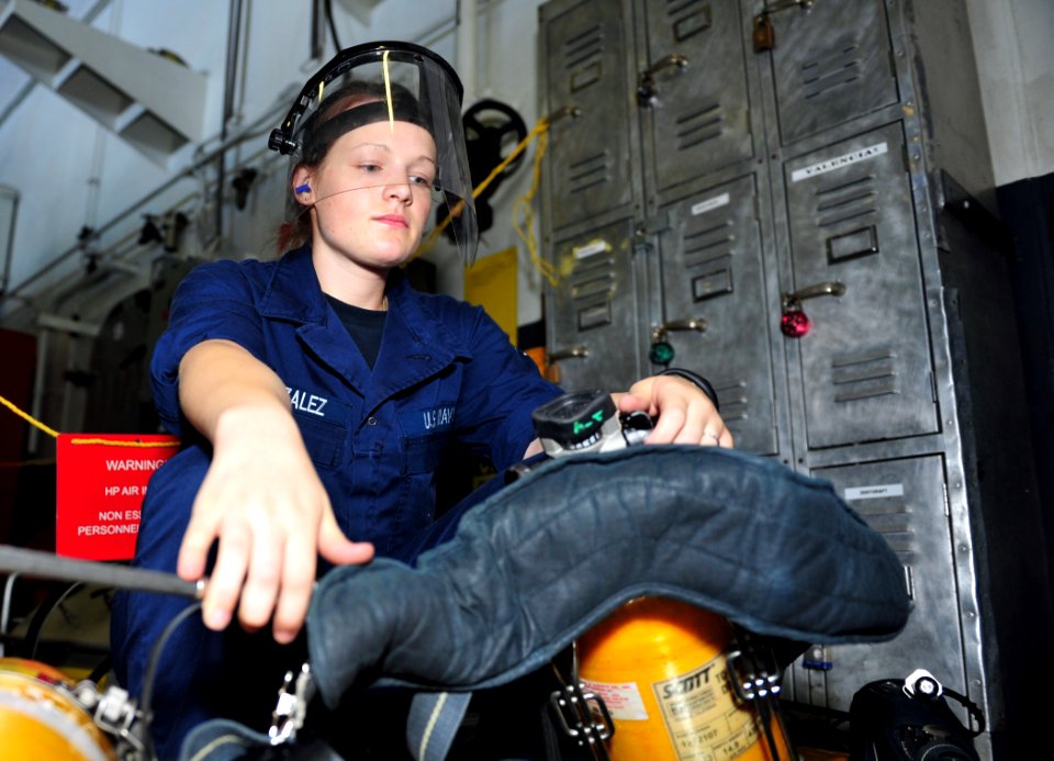 US Navy 110811-N-OI955-003 Damage Controlman Fireman Carol Gonzalez, from Adrian, Mich., refills a self-contained breathing apparatus (SCBA) bottl