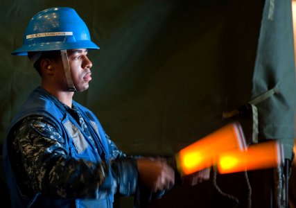 US Navy 110819-N-PB383-411 A USS New Orleans Sailor guides an AAV into the well deck