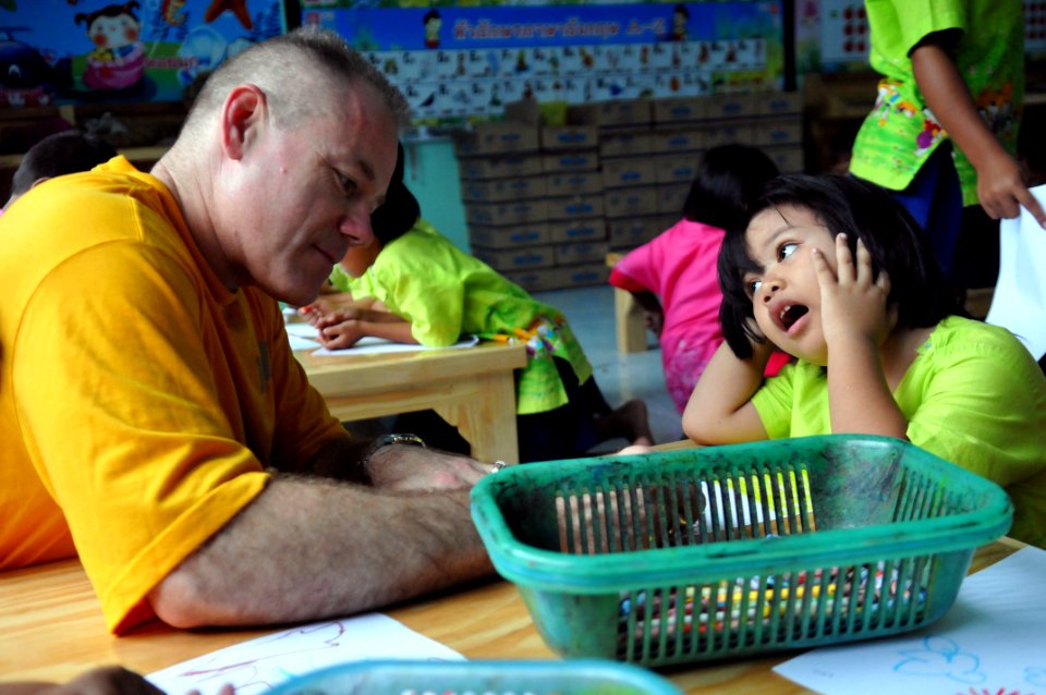 US Navy 110809-N-WW409-176 Command Master Chief Joseph Fahrney plays with students at the Wat Hua Yai School during a community service event in Pa