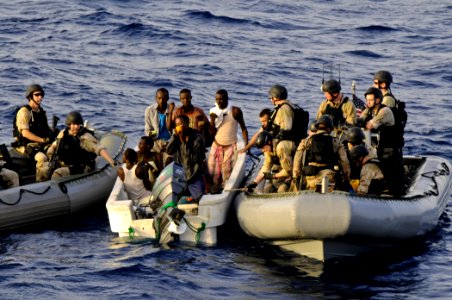 US Navy 110812-N-YM590-453 Members of a visit, board, search and seizure team from the guided-missile cruiser USS Anzio (CG 68) assist mariners abo