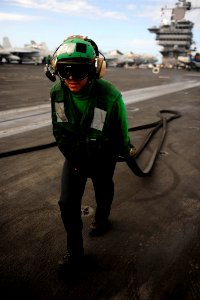 US Navy 110812-N-ZZ999-282 AB Miguel Bahena removes slot seals from catapults aboard the USS John C. Stennis